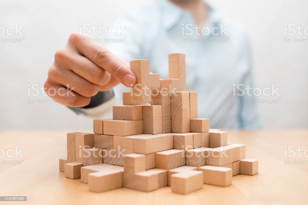 Man's Hand Stacking Wooden Blocks. Business Development Concept